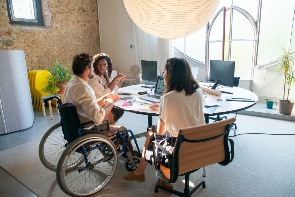 Disabled people in conversation at a table